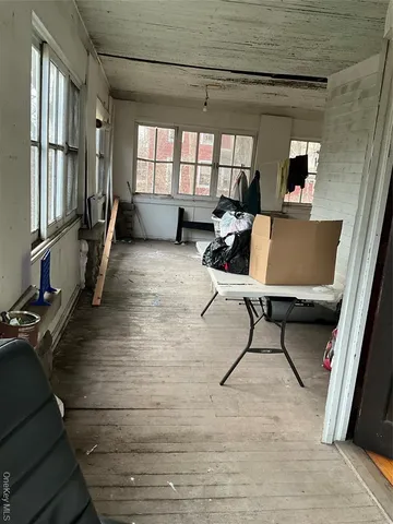 a view of a workspace with furniture window and wooden floor
