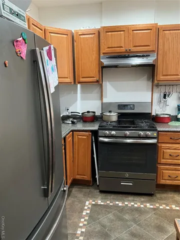 a kitchen with granite countertop a stove and cabinets