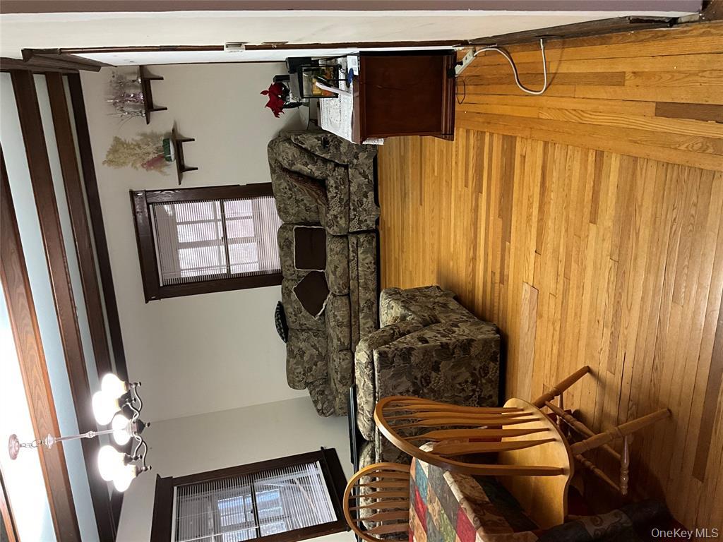 265 Spring Street Monroe, NY 10950 - Photo 4 of 20 a living room with furniture and a chandelier