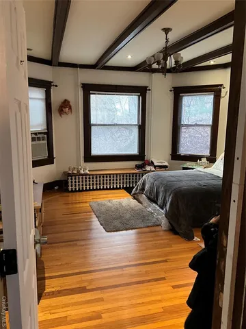 a bedroom with double bed and a dresser