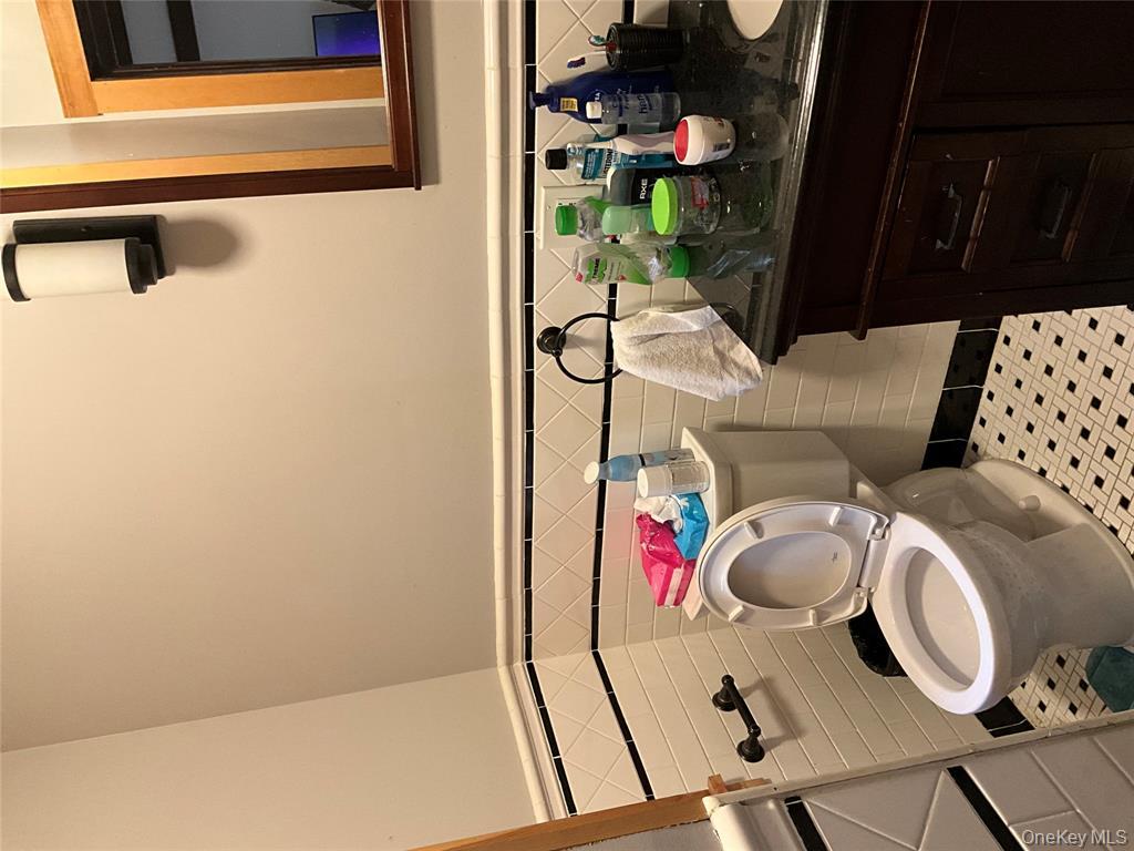 265 Spring Street Monroe, NY 10950 - Photo 7 of 20 a bathroom with a sink a toilet and shower