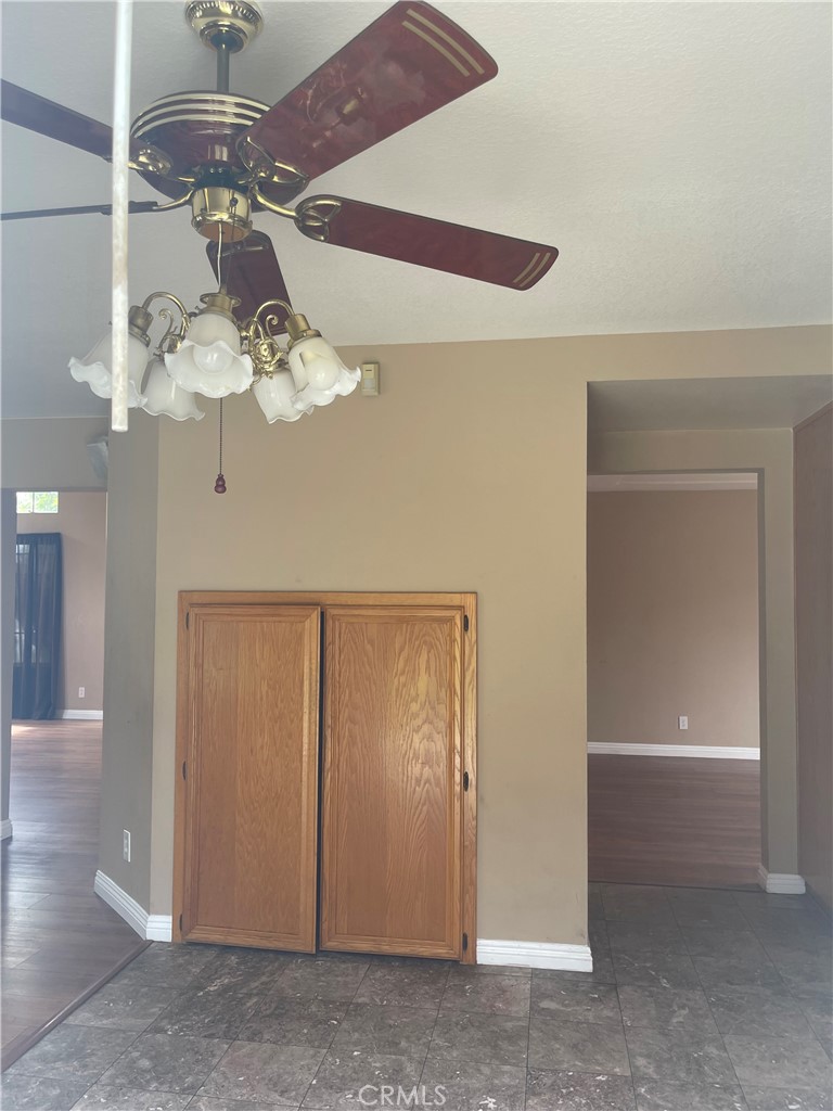 19284 Krameria Avenue Riverside, CA 92508 - Photo 25 of 26 a view of a hallway with a chandelier fan and wooden floor