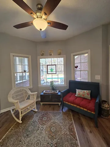 a view of a dining room with furniture window and wooden floor