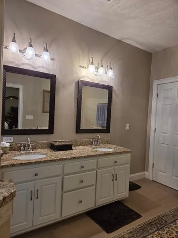a bathroom with a glass shower door and a mirror