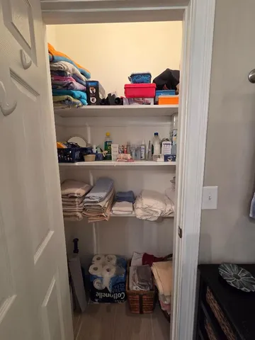 a bedroom with a bed and a lamp on dresser