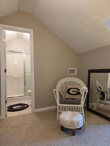 a bathroom with a toilet and a mirror