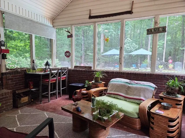 a swimming pool with outdoor seating and yard