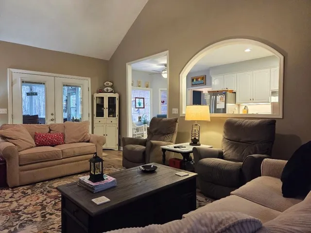 a large kitchen with sink a refrigerator and chairs