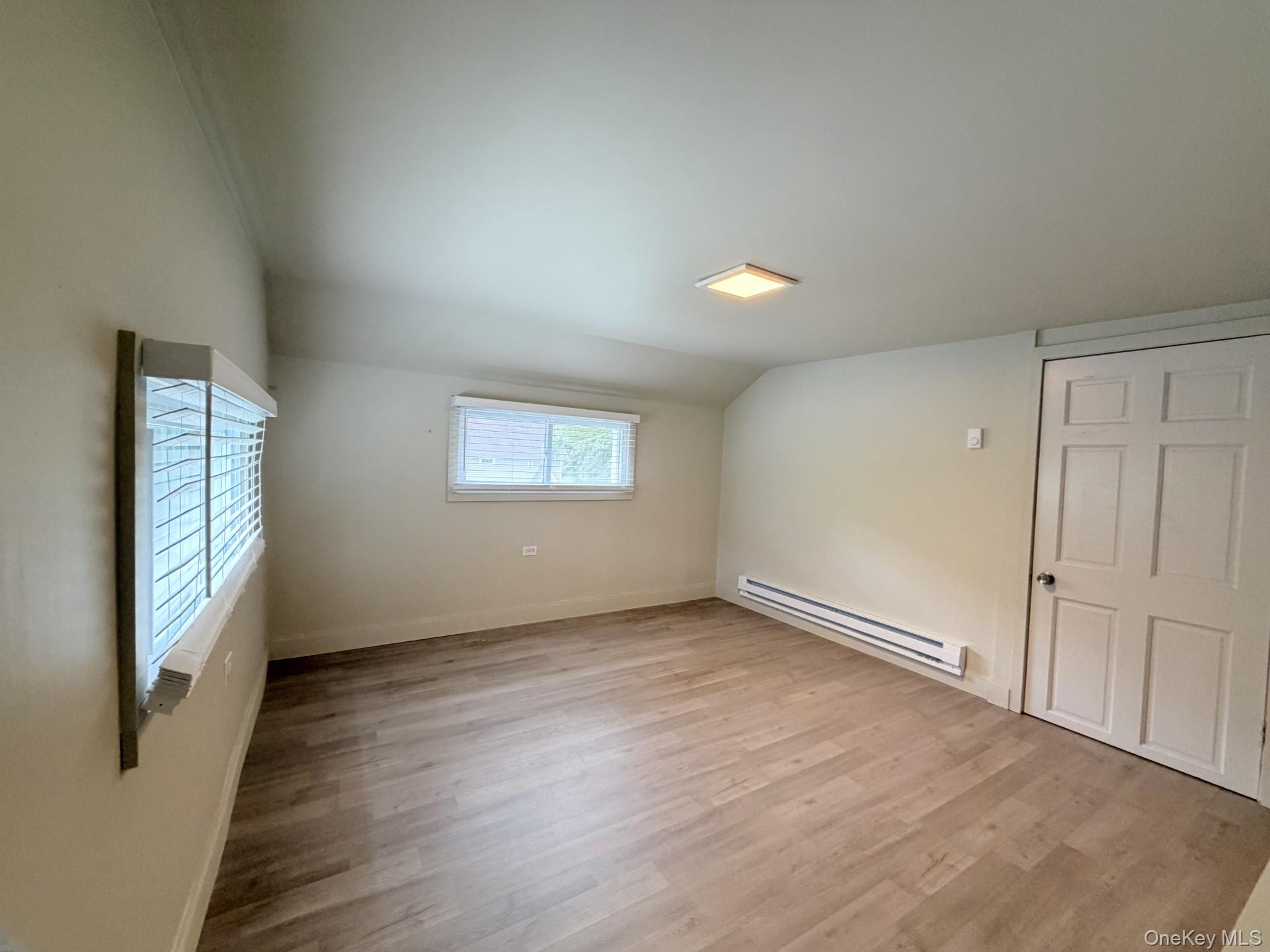 4 Lower Trinity Pass Road Pound Ridge, NY 10576 - Photo 28 of 29 an empty room with wooden floor and windows