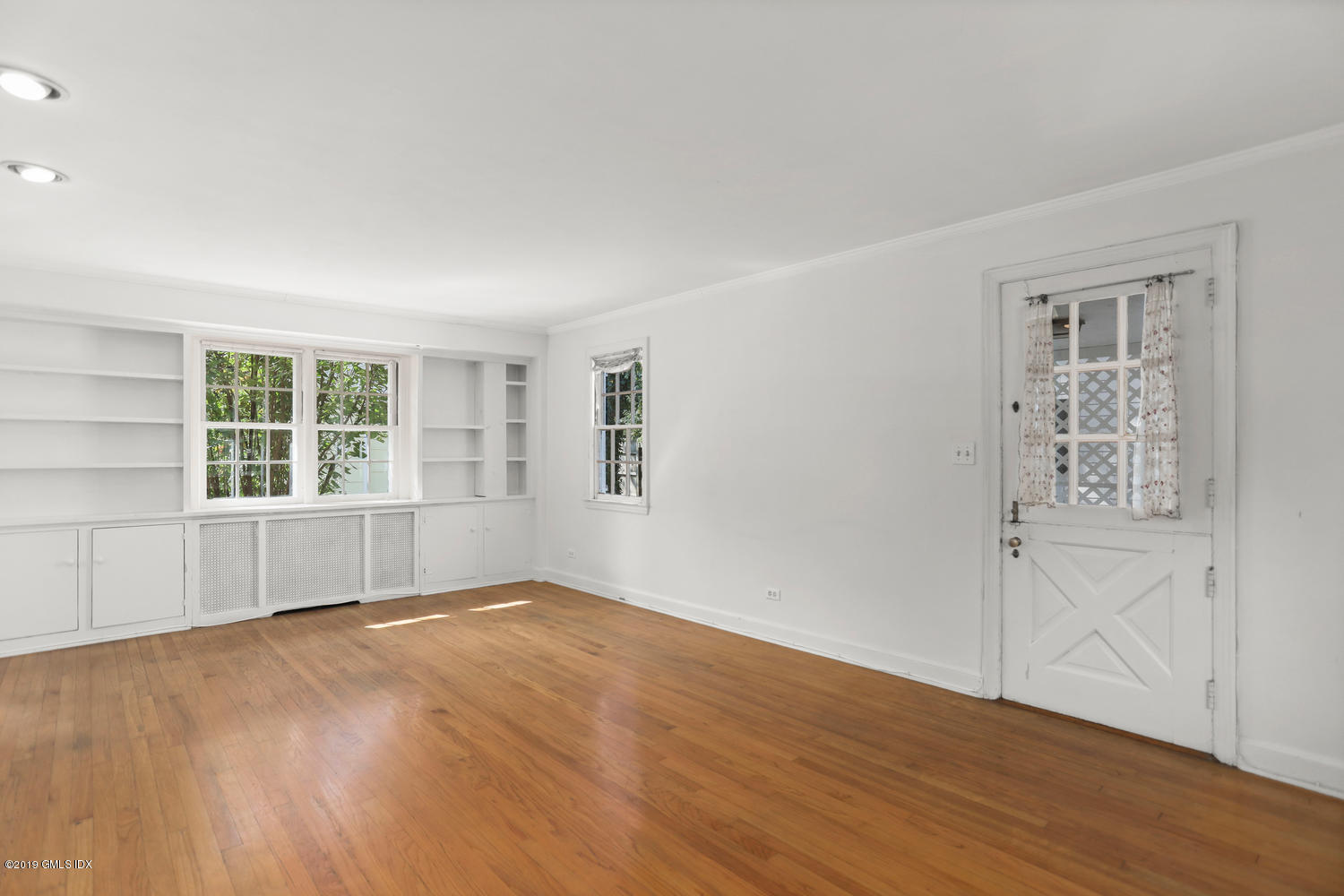 56 Summit Road Riverside, CT 06878 - Photo 2 of 24 an empty room with wooden floor and windows