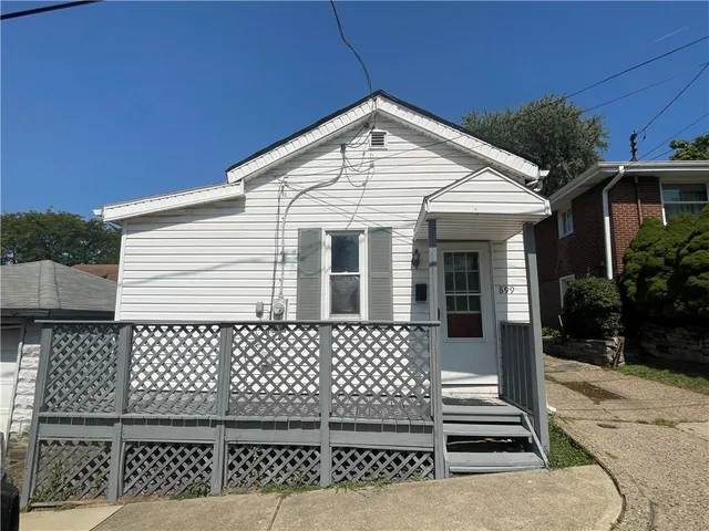 a front view of a house with a fence