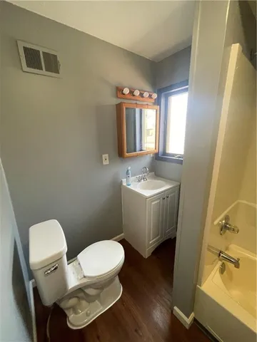 a white toilet sitting next to a bathroom sink