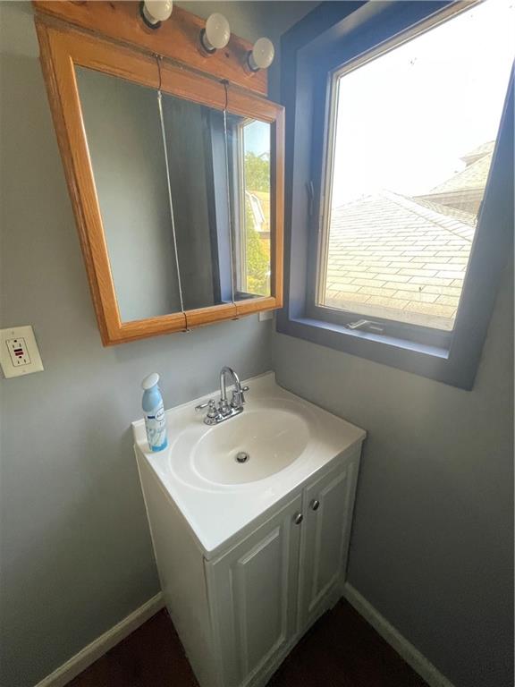 899 9th Street Ambridge, PA 15003 - Photo 13 of 18 a bathroom with a sink a mirror and a window