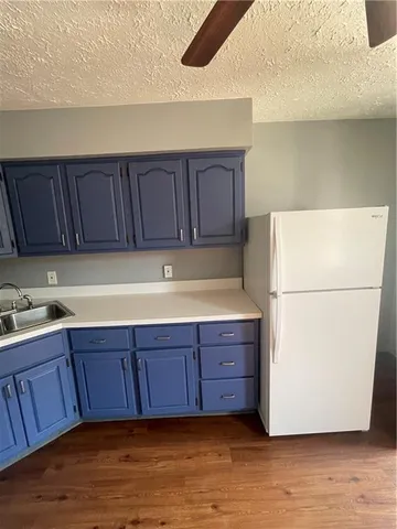 a kitchen with wooden cabinets and white appliances