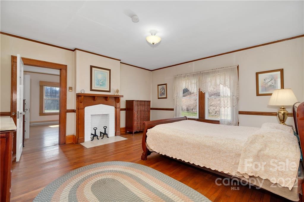 1715 Thickety Road Clyde, NC 28721 - Photo 14 of 25 a bedroom with a bed and wooden floor