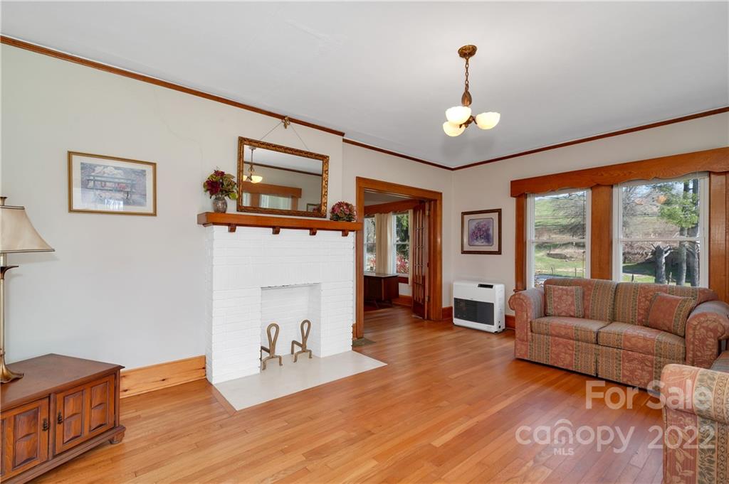 1715 Thickety Road Clyde, NC 28721 - Photo 7 of 25 a living room with furniture large window and wooden floor