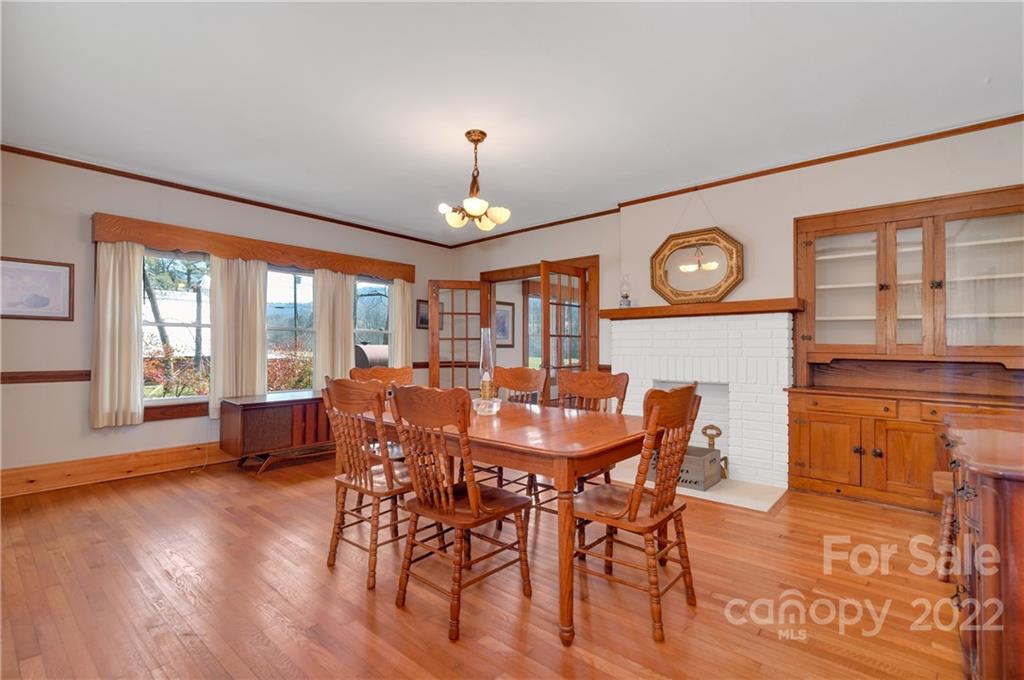 1715 Thickety Road Clyde, NC 28721 - Photo 8 of 25 a view of a dining room with furniture window and wooden floor