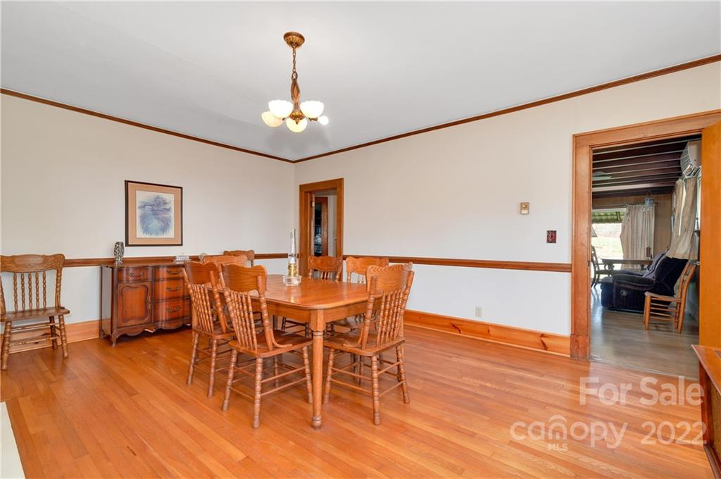 1715 Thickety Road Clyde, NC 28721 - Photo 9 of 25 a view of a dining room with furniture wooden floor and chandelier
