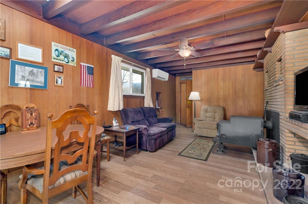 1715 Thickety Road Clyde, NC 28721 - Photo 10 of 25 a living room with furniture and a chandelier