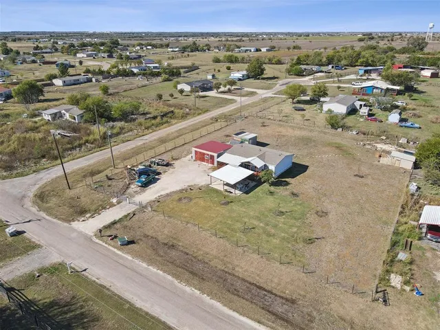 an aerial view of a house with a yard