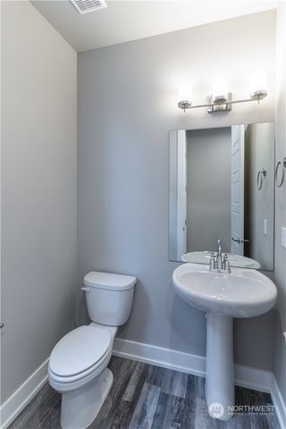 a bathroom with a sink toilet and a mirror