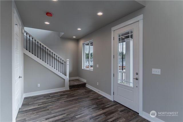 a view of entryway and hall with wooden floor