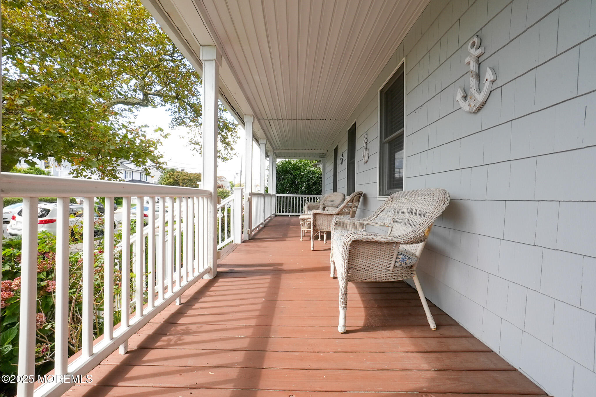 201 Forman Avenue Point Pleasant Beach, NJ 08742 - Photo 12 of 54 a balcony with wooden floor table and chairs