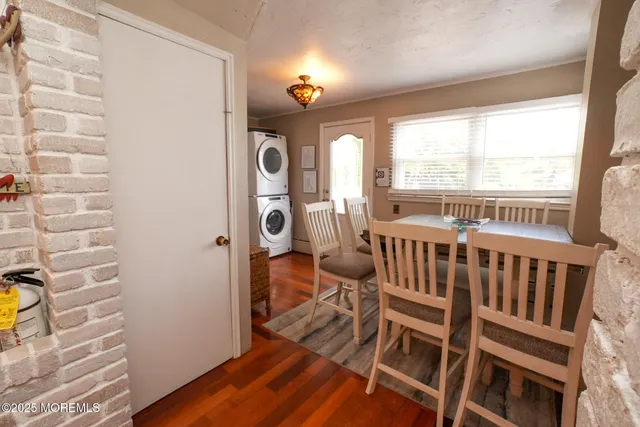 a kitchen with a table chairs refrigerator and a stove top oven