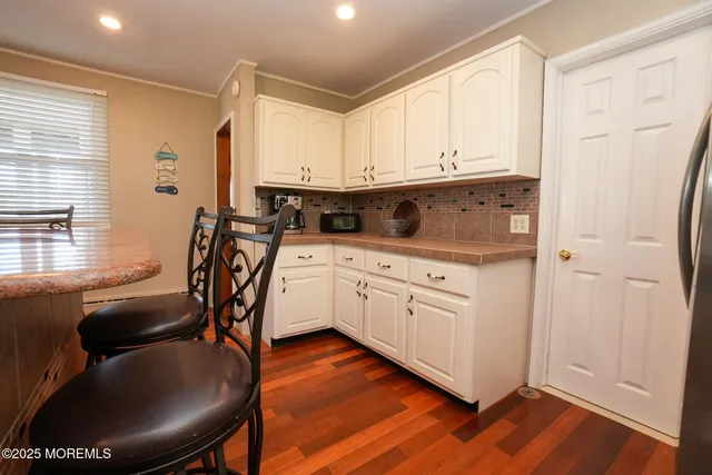 a spacious bedroom with a large bed and a chandelier