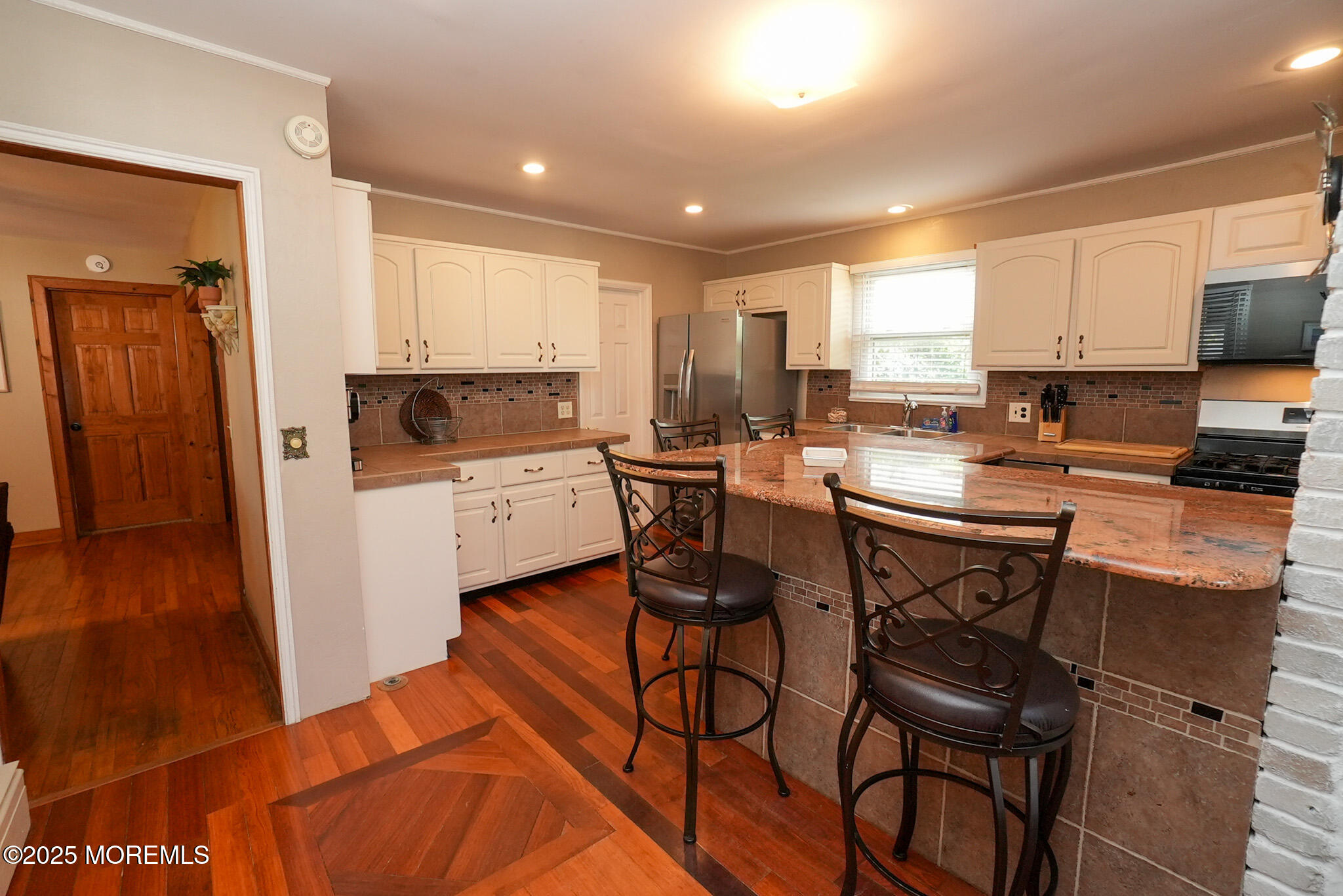 201 Forman Avenue Point Pleasant Beach, NJ 08742 - Photo 43 of 54 a kitchen with a table chairs refrigerator and a stove top oven