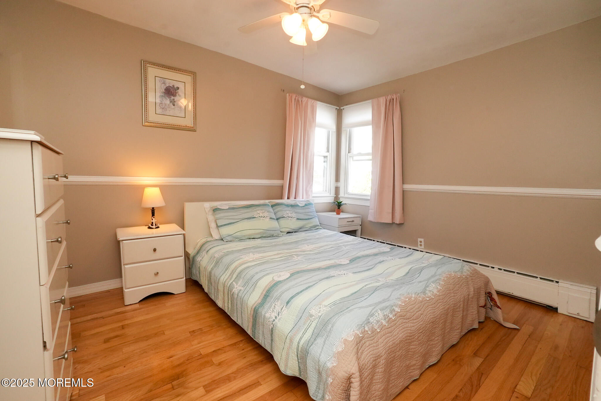 201 Forman Avenue Point Pleasant Beach, NJ 08742 - Photo 45 of 54 a spacious bedroom with a large bed and a chandelier