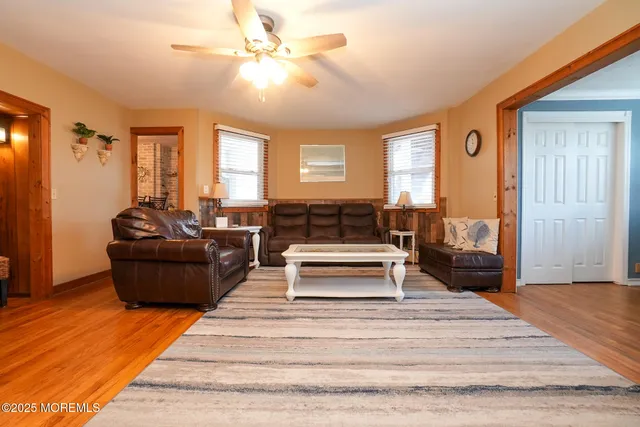a dining room with furniture and wooden floor