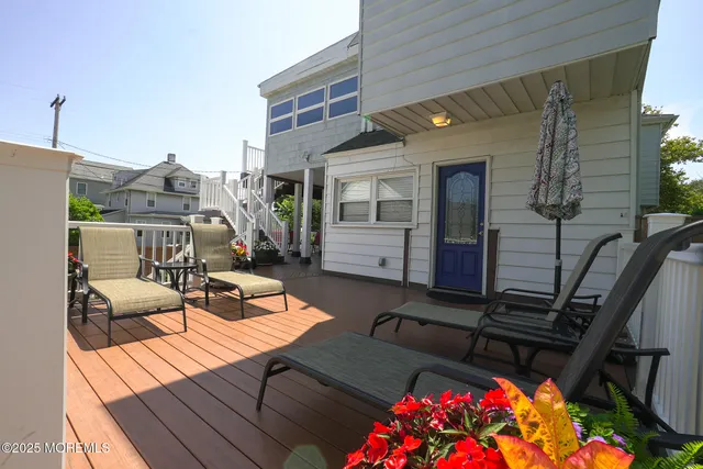 a view of a patio with table and chairs and wooden floor
