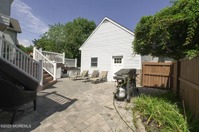 a living room with furniture and stairs