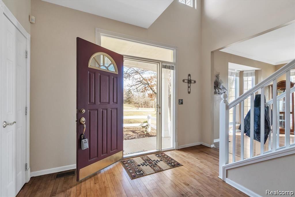 201 Timber Ridge Drive Highland, MI 48357 - Photo 5 of 39 Entryway into home with a two-story foyer