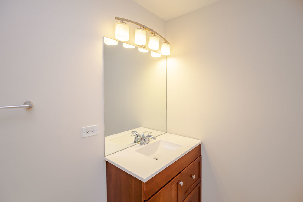 3349 North Clark Street, Unit 2SW Chicago, IL 60657 - Photo 12 of 13 a bathroom with a sink and a mirror