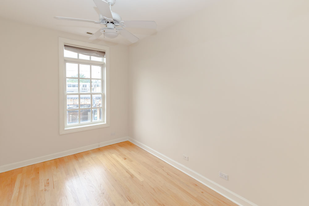 3349 North Clark Street, Unit 2SW Chicago, IL 60657 - Photo 10 of 13 an empty room with a window and wooden floor