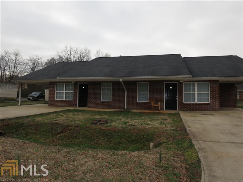 21 Dempsey Road Northeast, Unit 23 Rome, GA 30161 - Photo 1 of 1 a front view of a house with a garden and trees