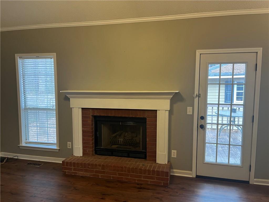 111 Green Point Way Carrollton, GA 30117 - Photo 11 of 29 a living room with a fireplace and wooden floor
