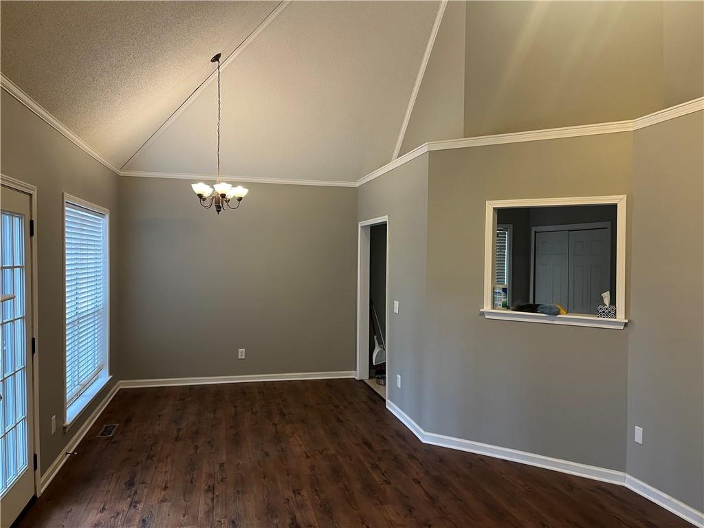 111 Green Point Way Carrollton, GA 30117 - Photo 13 of 29 an empty room with wooden floor fan and windows