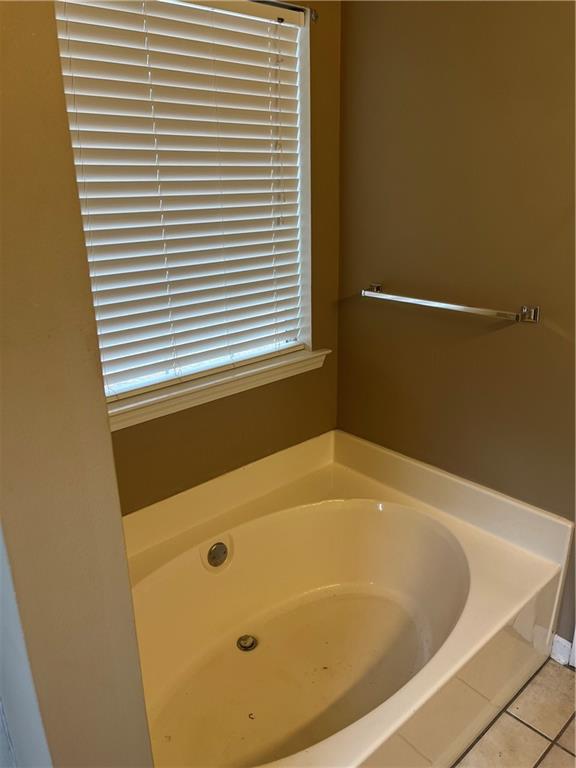 111 Green Point Way Carrollton, GA 30117 - Photo 8 of 29 a bathroom with a tub and a window