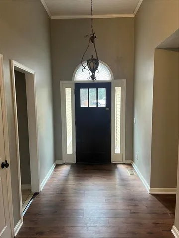 a living room with a fireplace and wooden floor