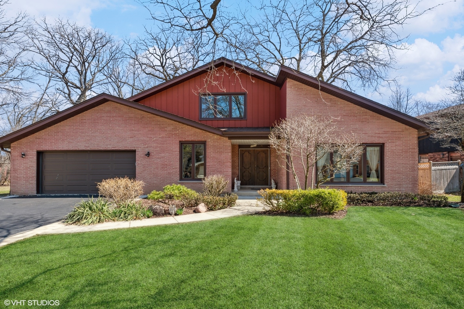 3905 Rugen Road Glenview, IL 60025 - Photo 1 of 31 a front view of a house with a garden and plants