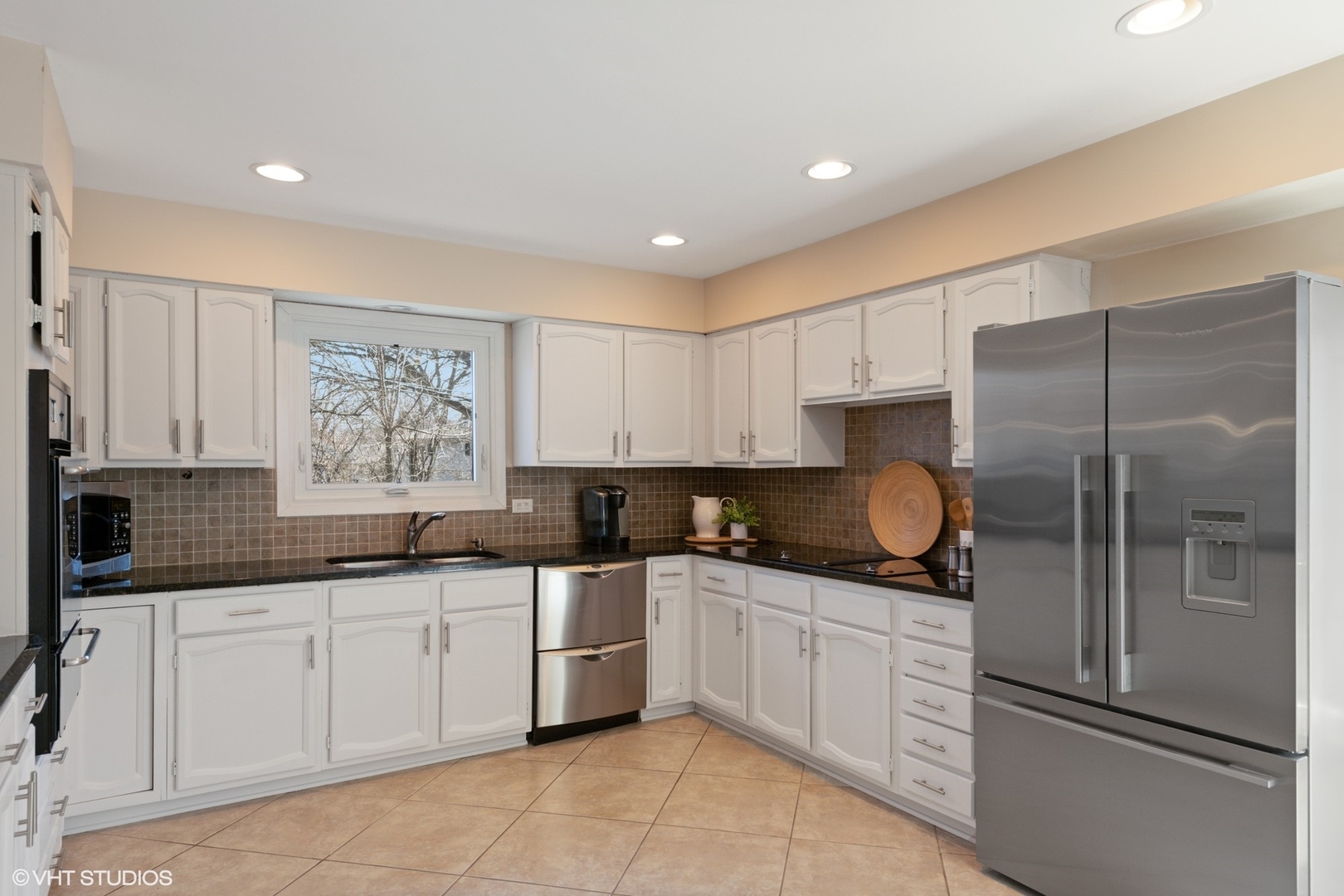 3905 Rugen Road Glenview, IL 60025 - Photo 7 of 31 a kitchen with a sink a refrigerator and cabinets