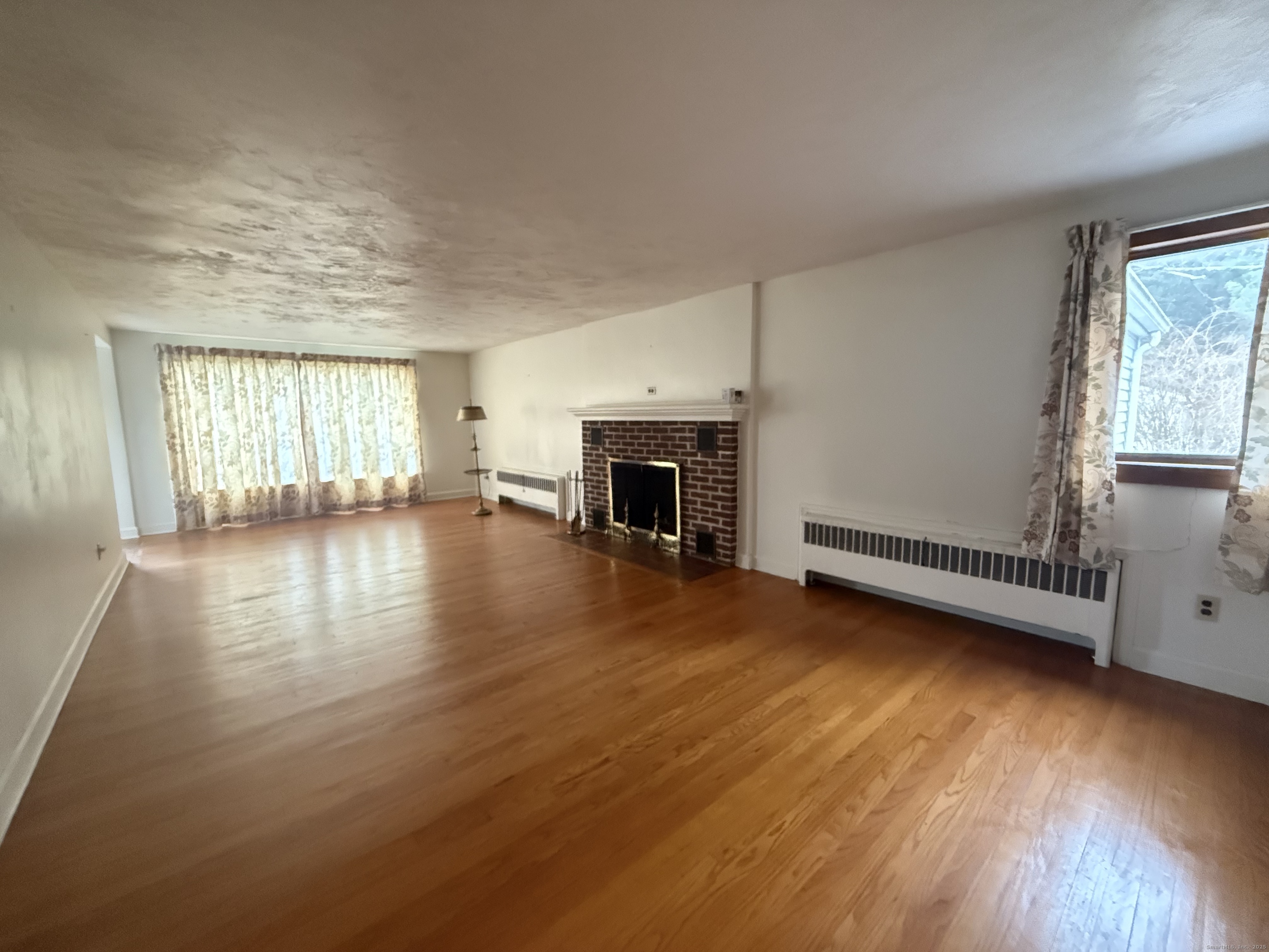 10 Top View Drive Thompson, CT 06262 - Photo 11 of 34 an empty room with wooden floor and fireplace