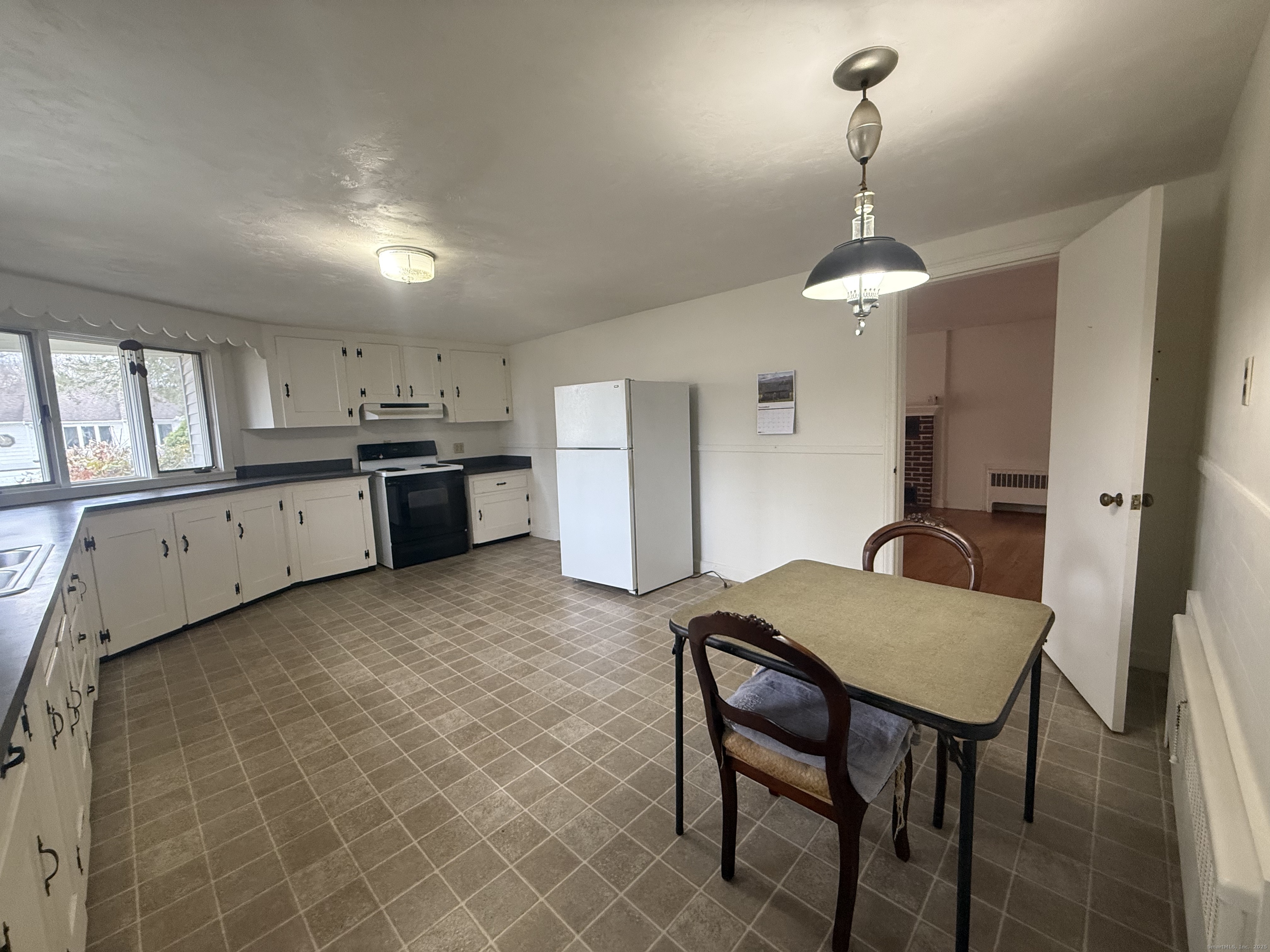 10 Top View Drive Thompson, CT 06262 - Photo 12 of 34 a kitchen with stainless steel appliances granite countertop a kitchen island a stove a table and chairs in it