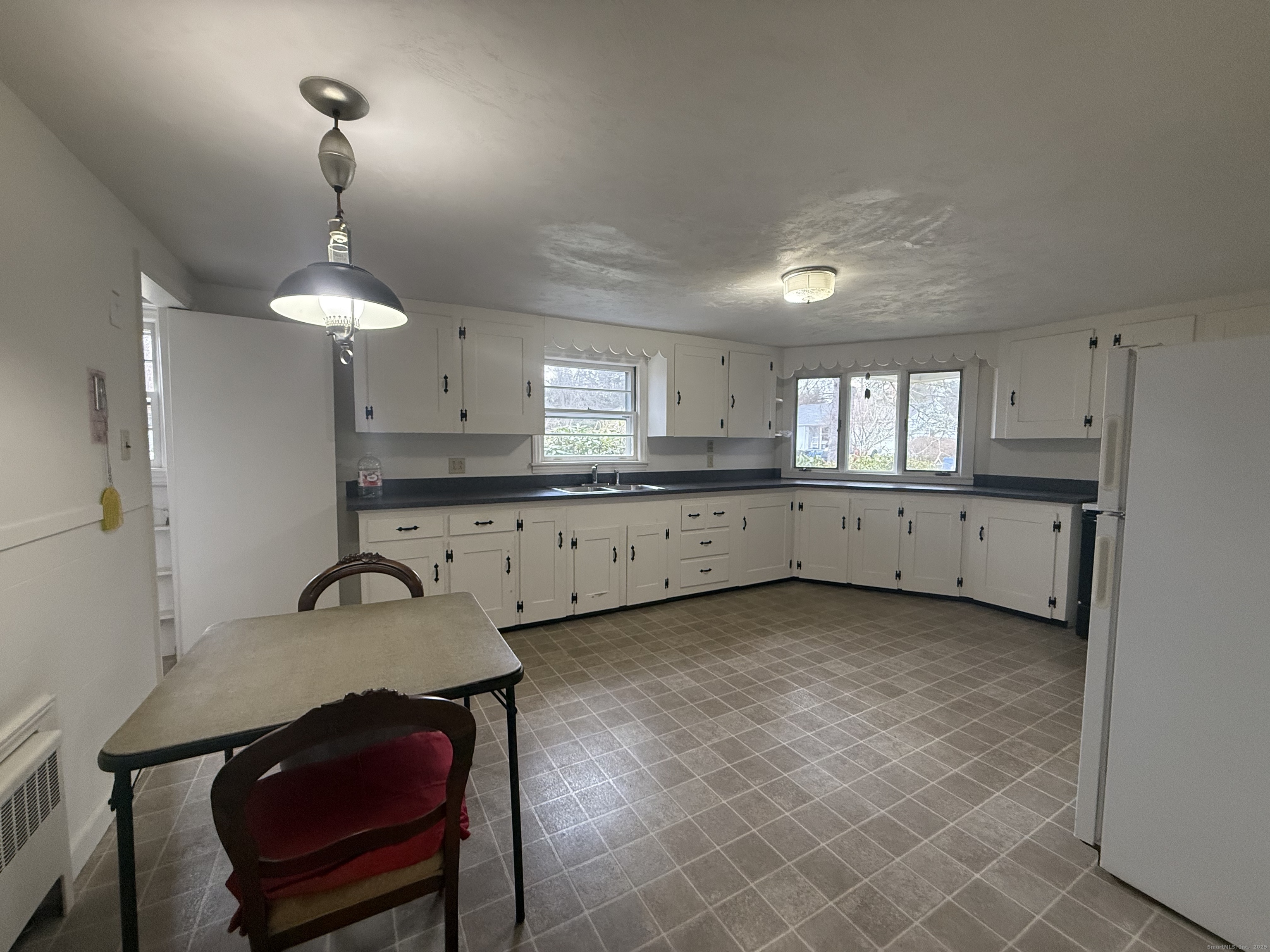10 Top View Drive Thompson, CT 06262 - Photo 13 of 34 a kitchen with granite countertop a sink cabinets and stove top oven
