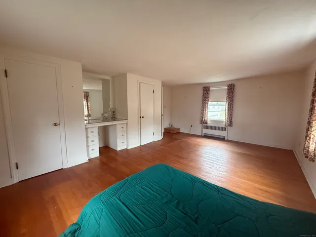 a bedroom with a bed and window