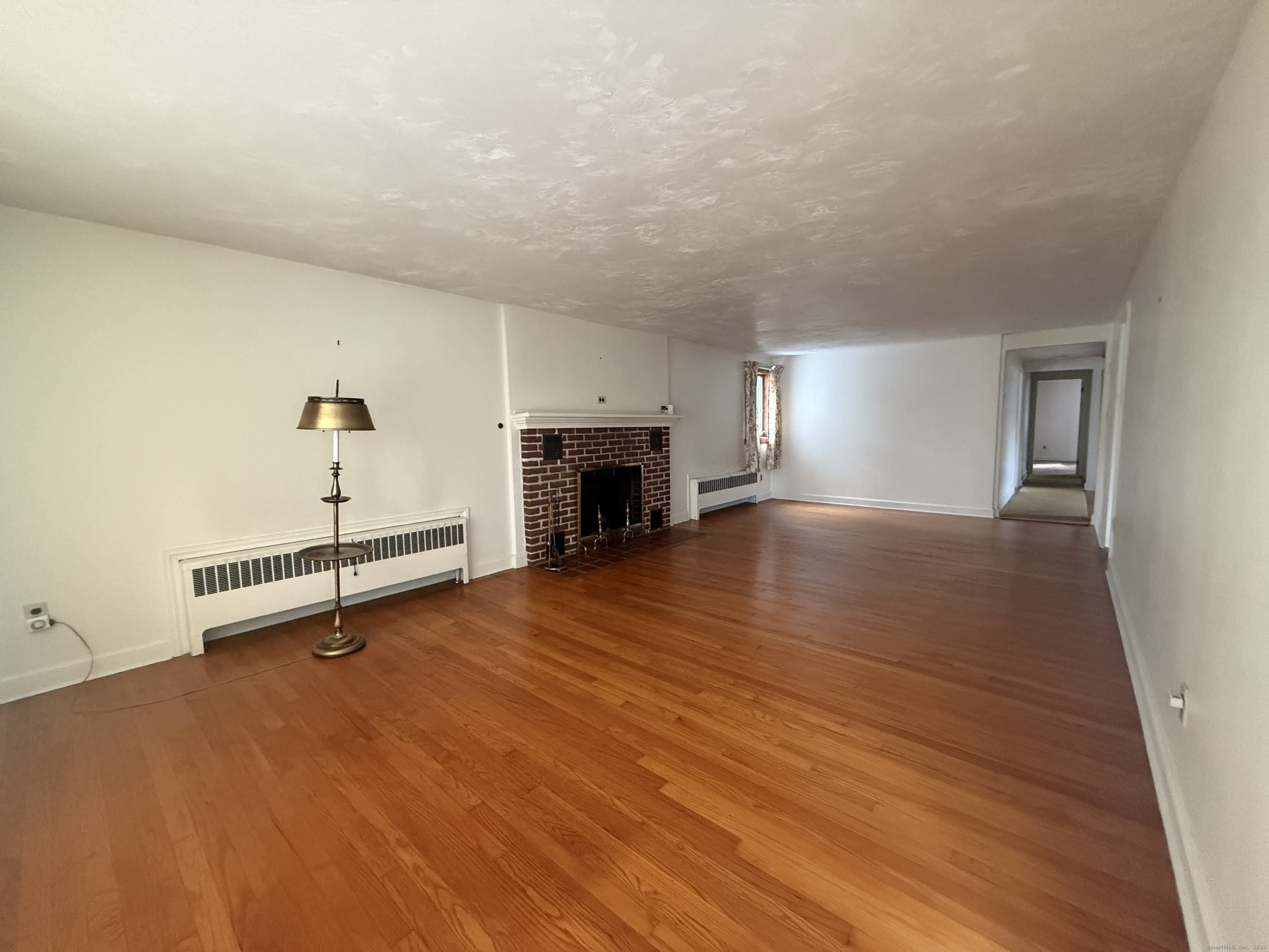 10 Top View Drive Thompson, CT 06262 - Photo 8 of 34 an empty room with wooden floor and fireplace