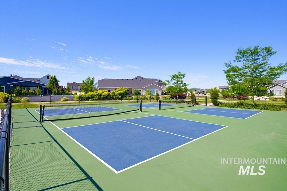 5897 West Riva Capri Street Meridian, ID 83646 - Photo 44 of 50 Recreational courts with green and blue surfacing, featuring multiple nets and white line markings